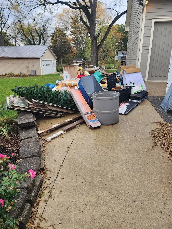 Dumpster being loaded with debris for 12 Yard Dumpster Rental in Anderson